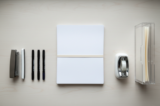 Back-to-school home office supply checklist — markers, stapler, file organizer, and tape on a clean desk